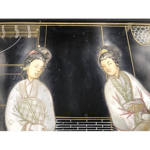 610 - A Japanese black lacquered jewellery box with a mother of pearl lid decorated with Geisha girls and ... 