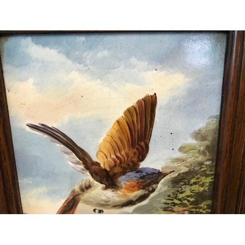 613 - An oak framed hand painted pottery tile of a pair of Kingfishers. Tile size 30cms h x 15cms w togeth... 