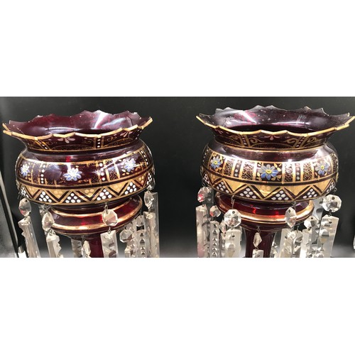 107 - A pair of gilt and floral painted ruby glass lustres with clear glass droplets. 39cms h.