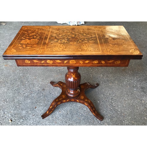 741 - A fine quality Victorian walnut inlaid fold over card table with reeded single pedestal base on four... 