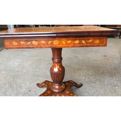 741 - A fine quality Victorian walnut inlaid fold over card table with reeded single pedestal base on four... 