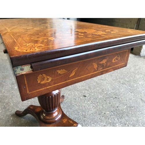 741 - A fine quality Victorian walnut inlaid fold over card table with reeded single pedestal base on four... 