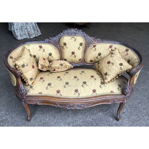 744 - A 19thC carved walnut framed two seater sofa, floral upholstered with matching cushions. Height to s... 