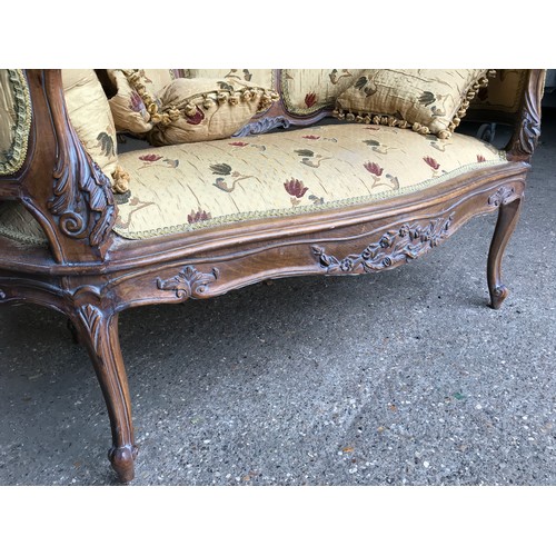 744 - A 19thC carved walnut framed two seater sofa, floral upholstered with matching cushions. Height to s... 