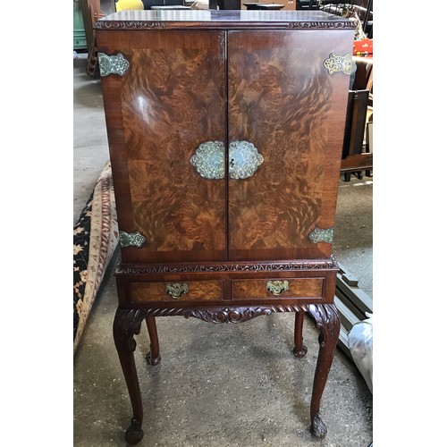 751 - A walnut mirrored back cocktail cabinet with decorative fittings, 2 drawers and cabriole legs. 60cms... 