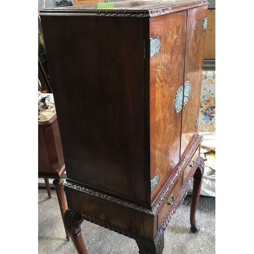 751 - A walnut mirrored back cocktail cabinet with decorative fittings, 2 drawers and cabriole legs. 60cms... 