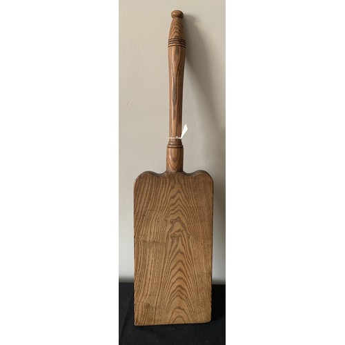 616 - An oak wash bat. 73cms l .