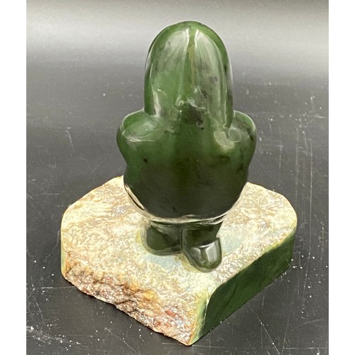 629 - A green stone Eskimo with a seal 13.5cms h together with an Indian pietra dura plaque.