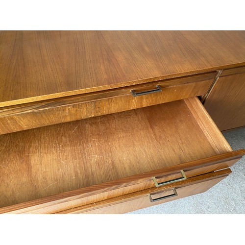 731 - A Merridew teak sideboard with 2 doors, 3 drawers. 199cms l x 45cms d x 76cms h.