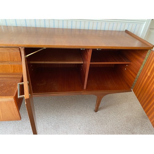 731 - A Merridew teak sideboard with 2 doors, 3 drawers. 199cms l x 45cms d x 76cms h.