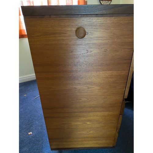 735 - A Merridew teak desk with 2 short over 2 long drawers. 111cms h x 119.5cms w x 45cms d.