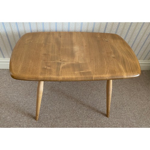 738 - An Ercol occasional table with original blue paper badge. 68.5cms x 42cms x 43.5cms h.