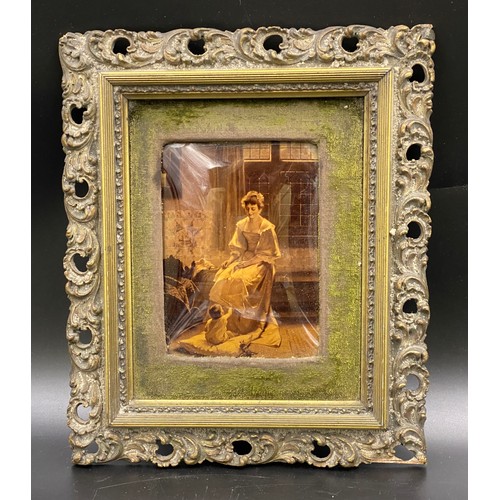 676 - A framed crystoleum of a seated lady with a baby. 13cms x 9cms. Frame 26cms x 22cms.