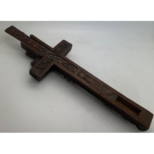 633 - A well carved crucifix with sliding compartment to rear, 24cms l.