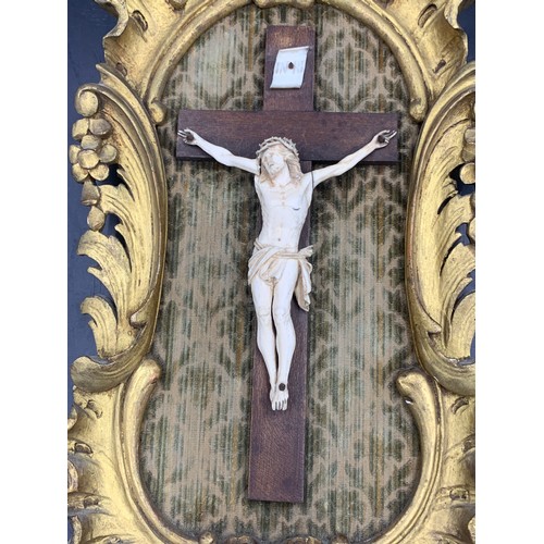 634 - Crucifix in gilt wood frame with fabric backing.