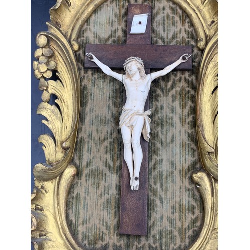 634 - Crucifix in gilt wood frame with fabric backing.