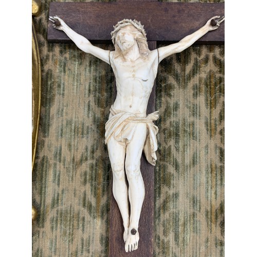 634 - Crucifix in gilt wood frame with fabric backing.