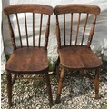 A pair of stick back dining chairs with oak seats and beechwood frames. Height to seat 45cms, to bac... 