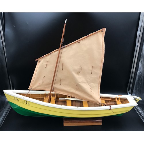 637 - A wooden model boat with sail 