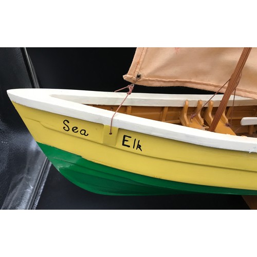 637 - A wooden model boat with sail 