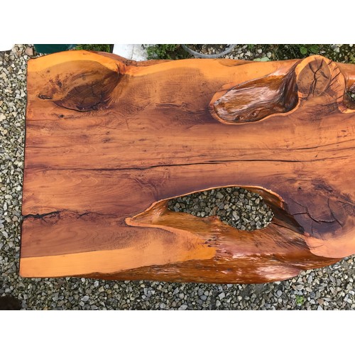 725 - A natural pine coffee table on teak legs. 125cms w x 59cms d x 41cms h.