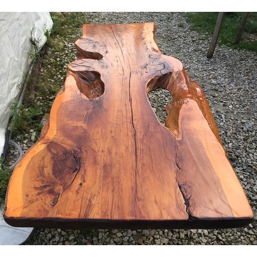 725 - A natural pine coffee table on teak legs. 125cms w x 59cms d x 41cms h.