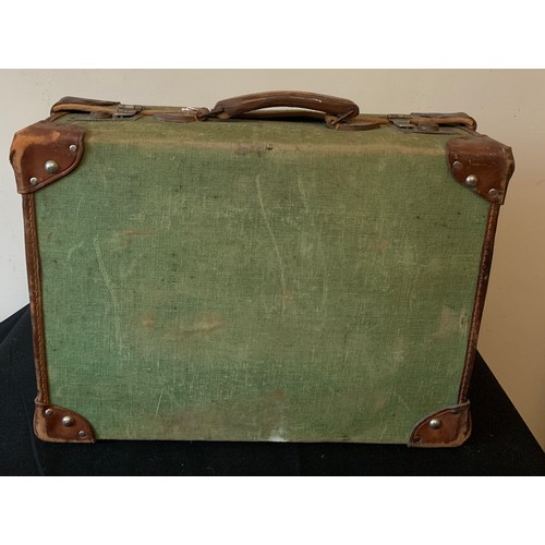 646 - A vintage canvas and leather suitcase. 51 x 37cms.