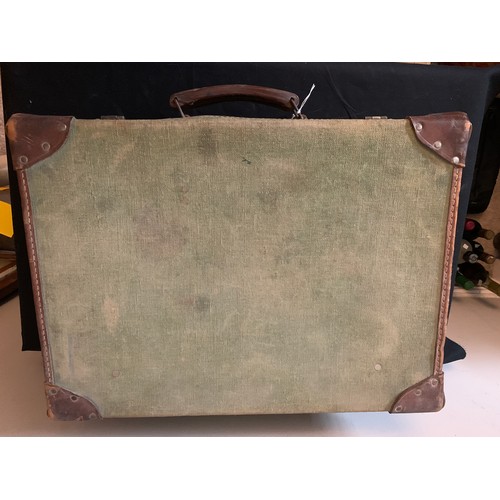 646 - A vintage canvas and leather suitcase. 51 x 37cms.