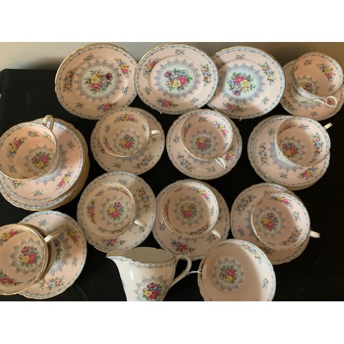 82 - A Shelley tea service comprising 10 cups, 11 saucers, 12 plates, milk and sugar.