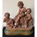 A plaster group of cherubs and a goat, signed Cipriani?