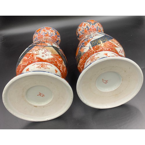 77 - A pair of 19thC Imari vases 31.5cms h.