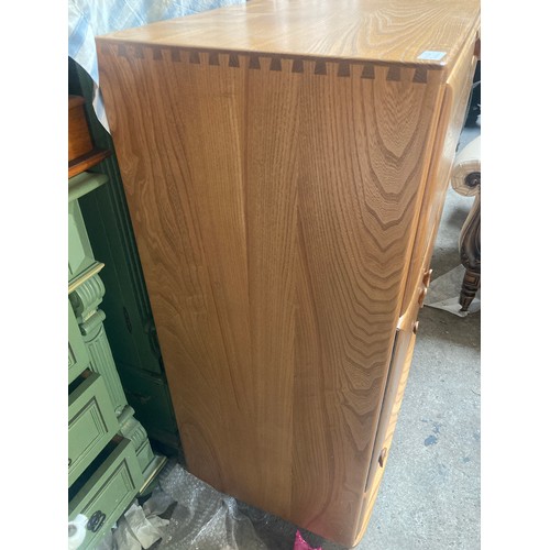 810 - An Ercol drinks cabinet, over 2 cupboard and long drawer. 82 w x 43 d x 110cms h.