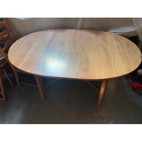 811 - An Ercol extending dining table and six chairs.