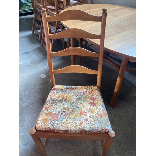 811 - An Ercol extending dining table and six chairs.