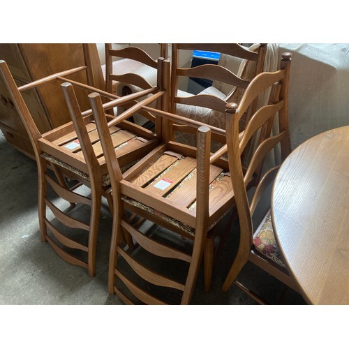 811 - An Ercol extending dining table and six chairs.