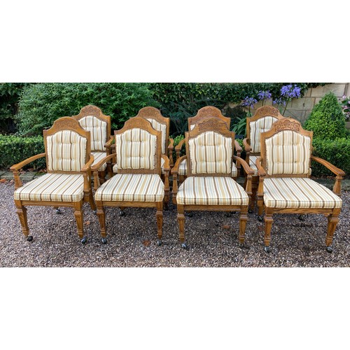 777 - A set of 8 oak carver dining chairs with rattan backs and cushions and carving to crest rail.