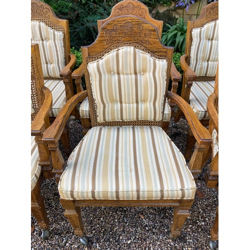 777 - A set of 8 oak carver dining chairs with rattan backs and cushions and carving to crest rail.