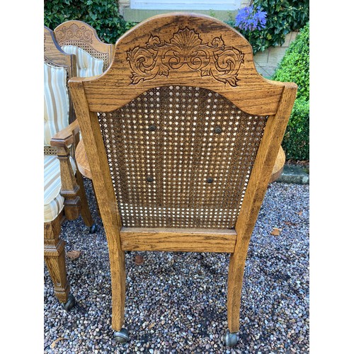 777 - A set of 8 oak carver dining chairs with rattan backs and cushions and carving to crest rail.