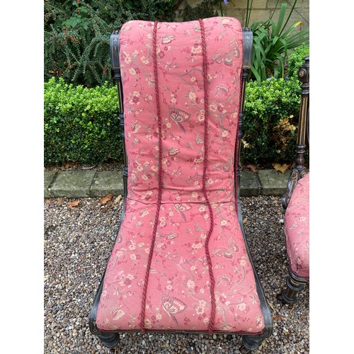 780 - Two Victorian ebonised and gilt upholstered nursing chairs both with turn front legs ans castors.