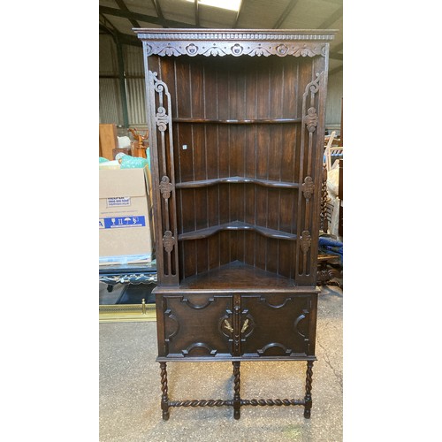 781 - A corner cabinet with lower door. 192 h x 83 w x 62cms d.