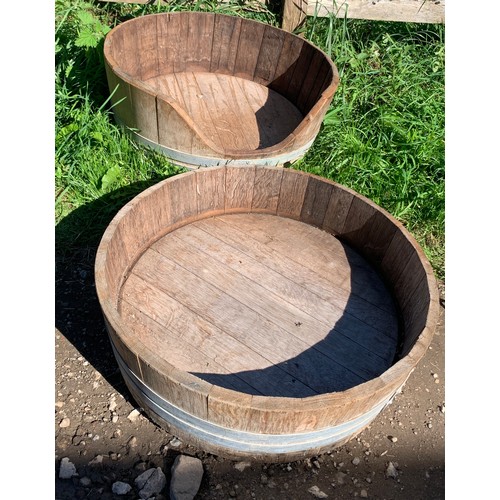 821 - Two wooden coopered planters. One cut down to one side. 63 d x 20cms h.