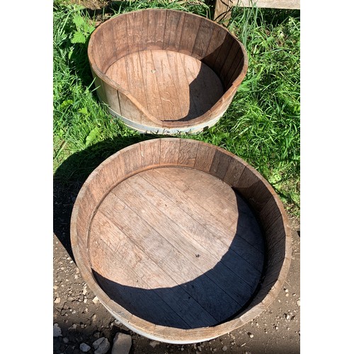 821 - Two wooden coopered planters. One cut down to one side. 63 d x 20cms h.