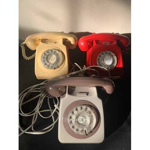 648 - Three vintage telephones, red, cream and brown.