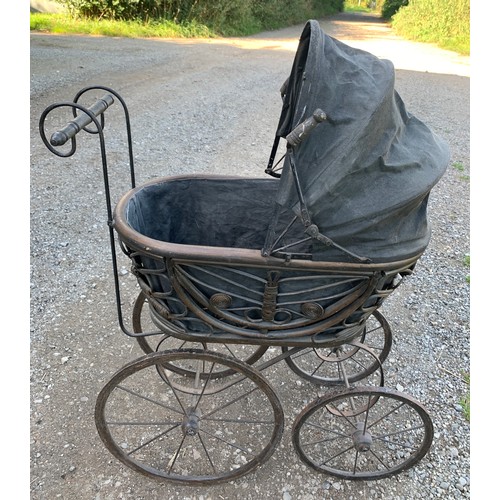 649 - A cane and metal dolls pram. 54 l x 35 w x 87cms l.