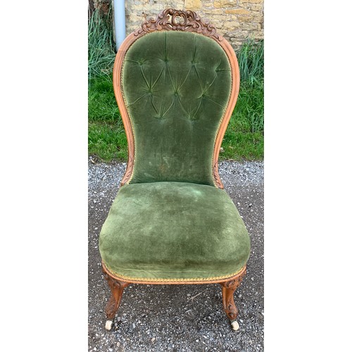 790 - A 19thC upholstered nursing chair on cabriole legs and porcelain casters, buttoning to back.