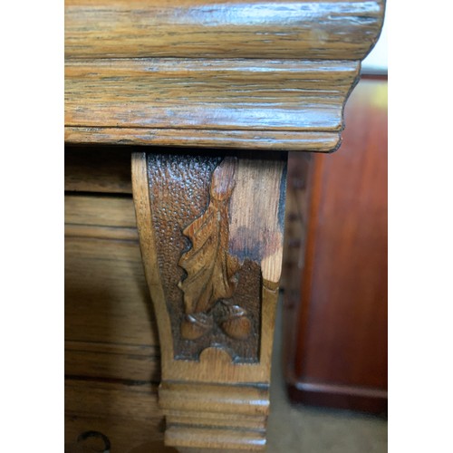 794 - An early 20thC oak Arts and Crafts sideboard. Three cupboards and three drawers with brass handles a... 