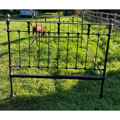 796 - A 19thC brass and iron double bedstead. 4'6'' wide with iron and wooden slats.