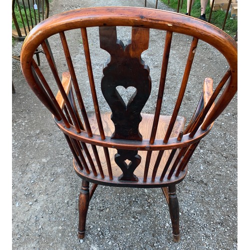 784 - A 19thC elm, ash and yew wood Windsor chair with crinoline stretcher.