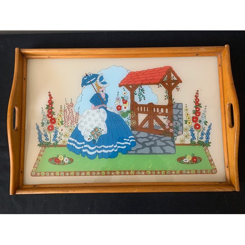 580A - A Vintage glass galleried tray depicting a lady in a garden. 32 x 52cms.