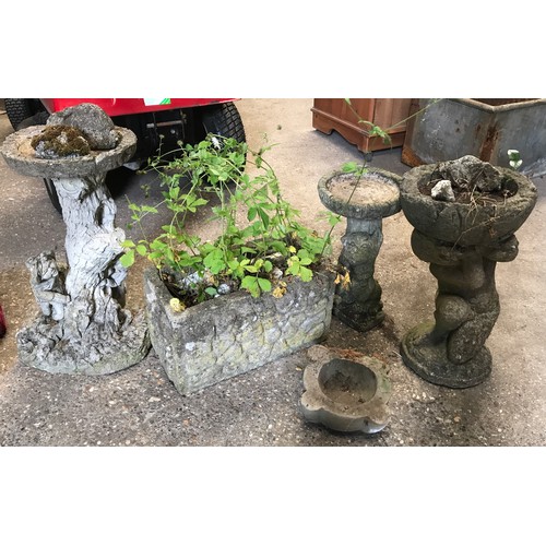 827 - Five concrete garden ornaments to include 2 bird baths one 58cms h and 40cms h, a boy with planter 5... 